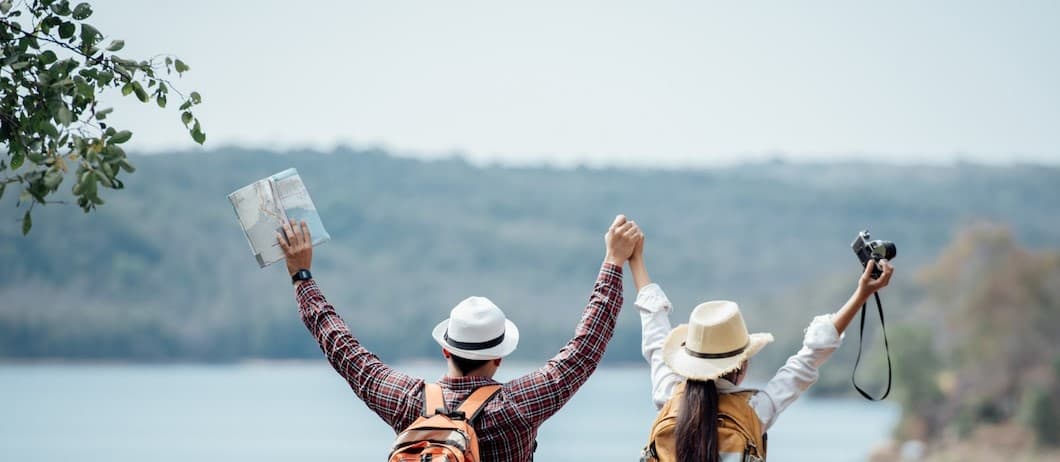 Couple holding hands in front of mountain